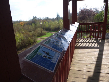 Interpretive displays along the railing of shelter – wooden deck – view of refuge